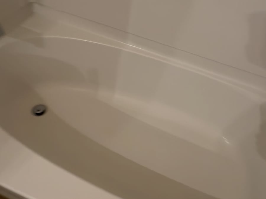 The same bathtub scrubbed white after our deep clean