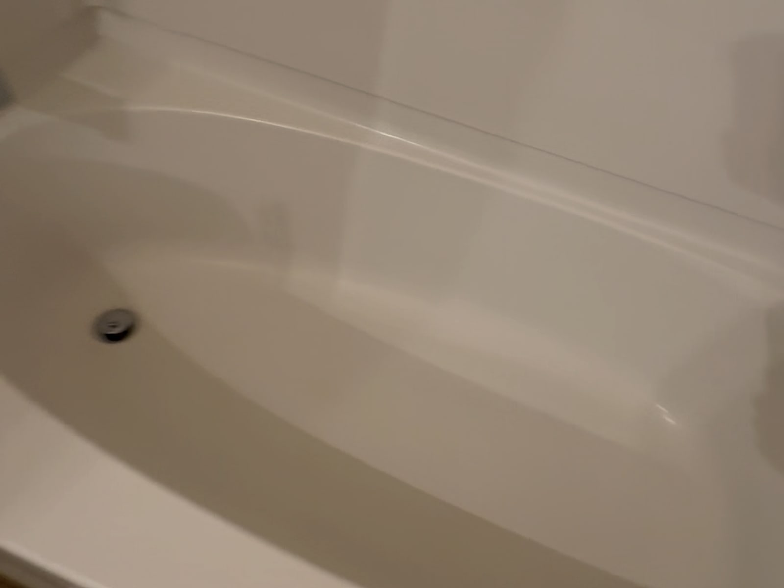 The same bathtub scrubbed white and guest-ready after our turnover clean