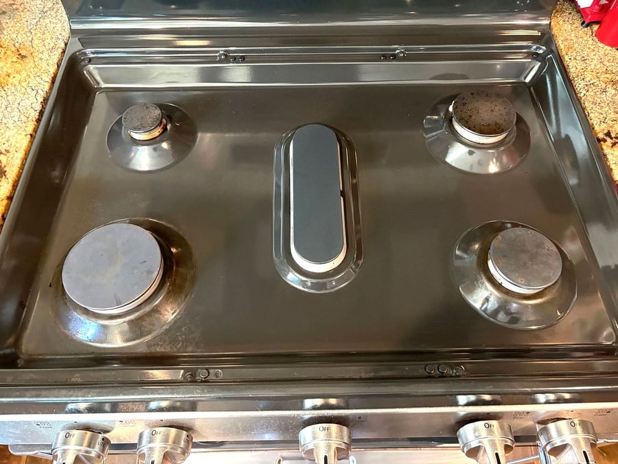 The same gas cooktop degreased and polished after our deep clean