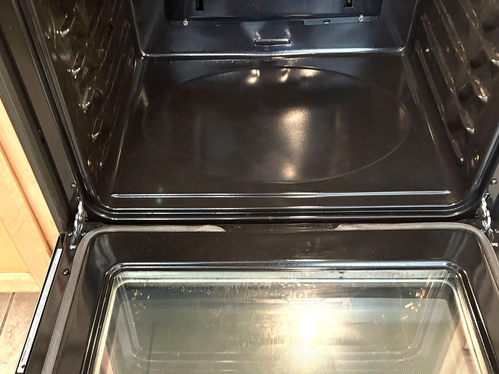 The same oven interior scrubbed clean after our move-out clean