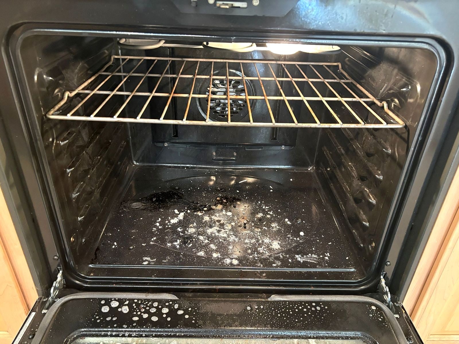 Oven interior with burnt-on spills before a move-out clean