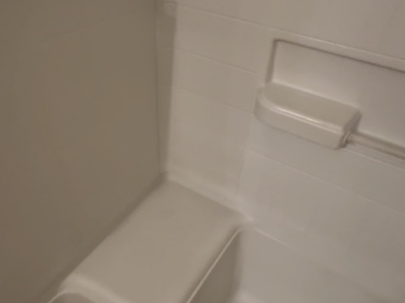 The same shower stall and seat cleaned and guest-ready after our turnover