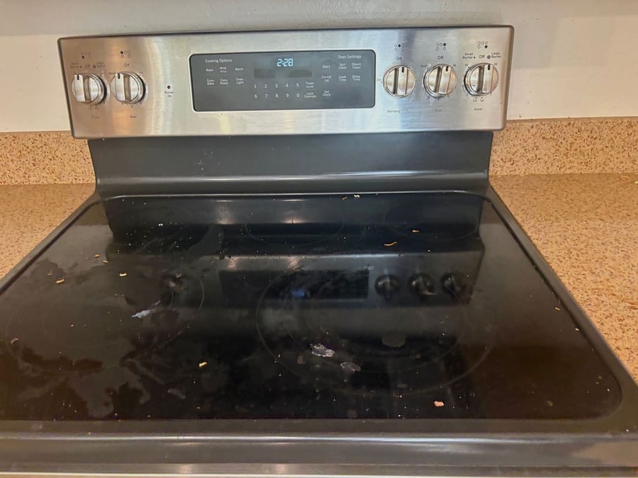 Glass stovetop with smears and residue before a clean