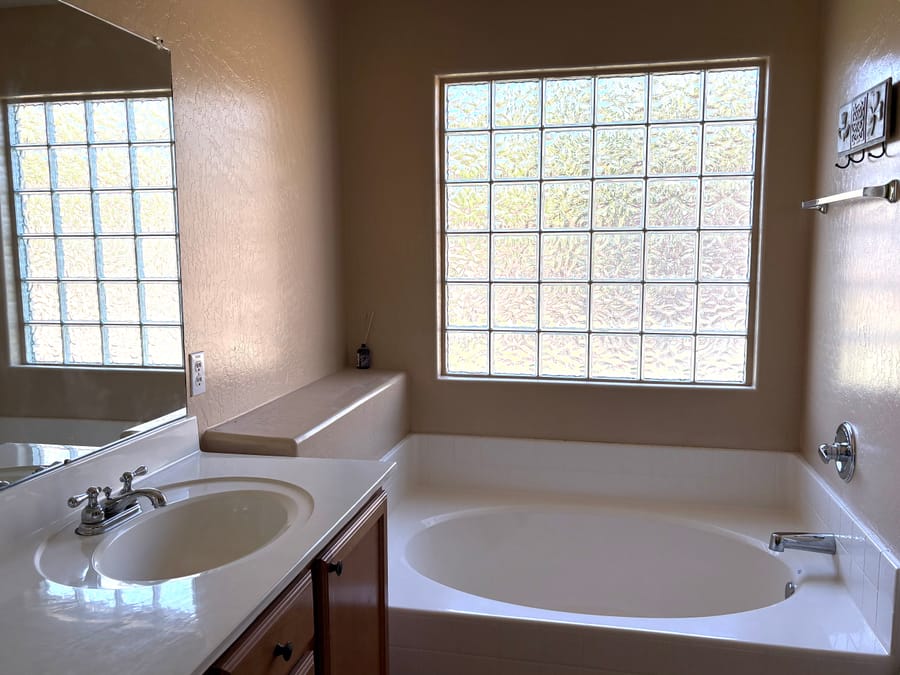 Bright bathroom with a soaking tub, cleaned and reset between guest stays