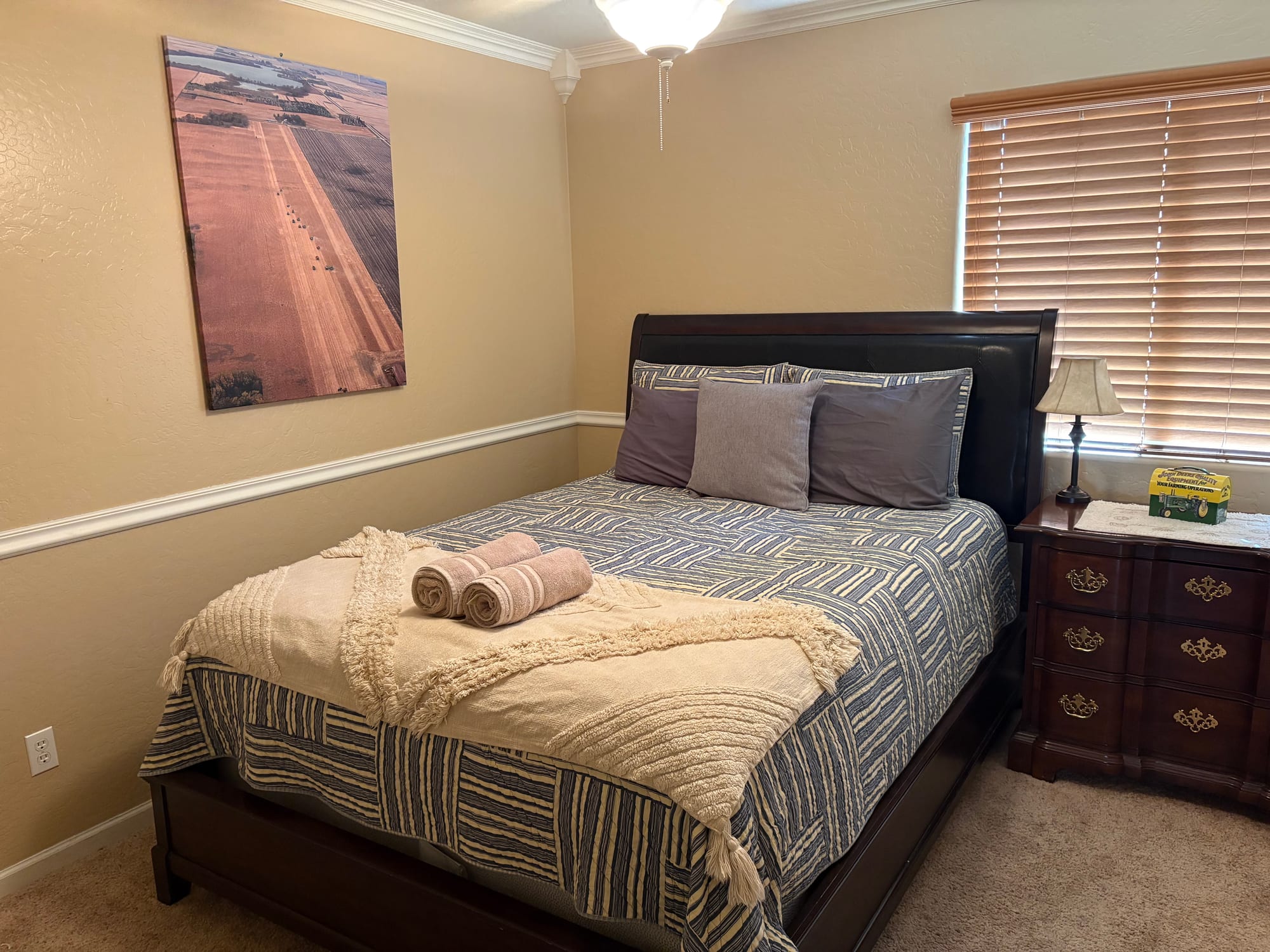 Guest bedroom staged with fresh towels after a turnover clean