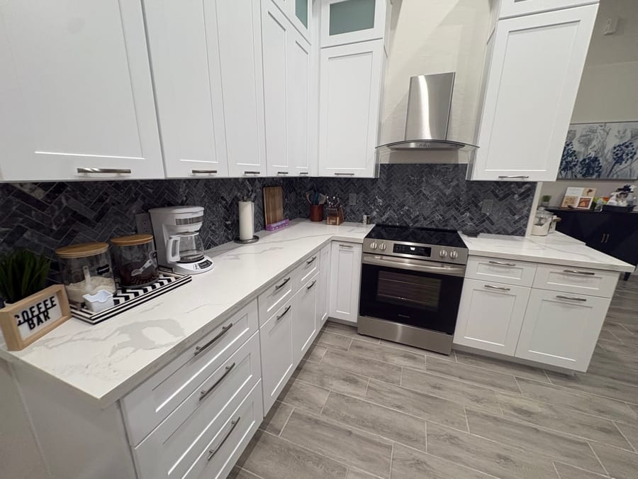 White kitchen with quartz counters wiped down and staged after a house cleaning
